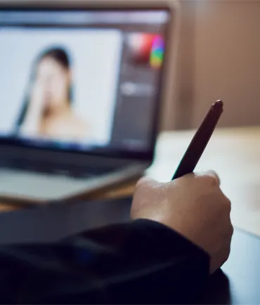 Designer Using modern digital tools to edit an image on the computer